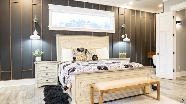 bedroom featuring ornamental molding and light wood-style floors