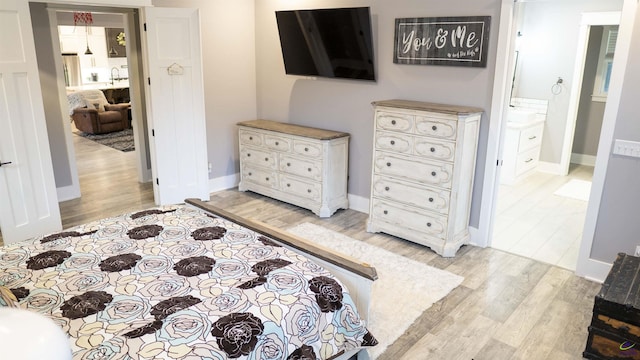 bedroom featuring baseboards and light wood-type flooring