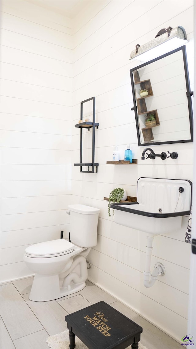 bathroom featuring toilet and wood finished floors