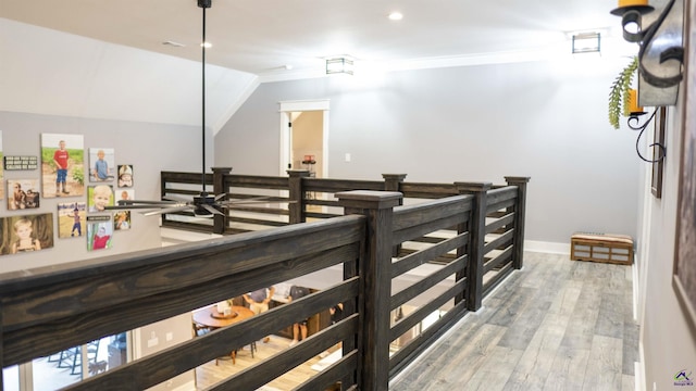 corridor with vaulted ceiling, light wood finished floors, baseboards, and recessed lighting