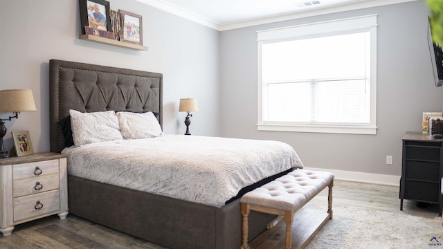 bedroom featuring crown molding, visible vents, baseboards, and dark wood-style floors