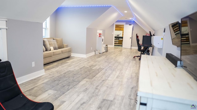 office with vaulted ceiling, baseboards, and wood finished floors