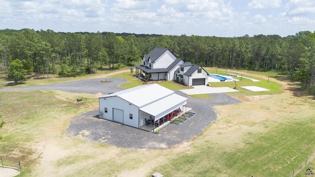 bird's eye view with a wooded view