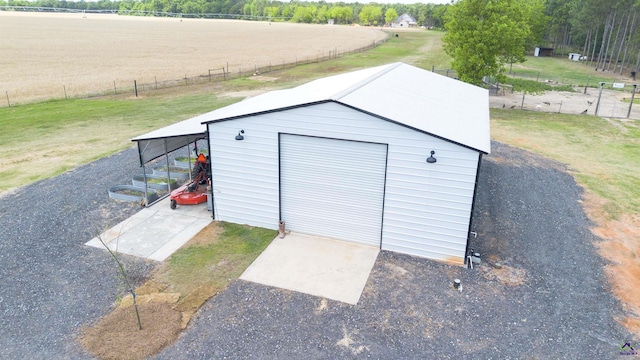 view of outdoor structure featuring an outbuilding and fence