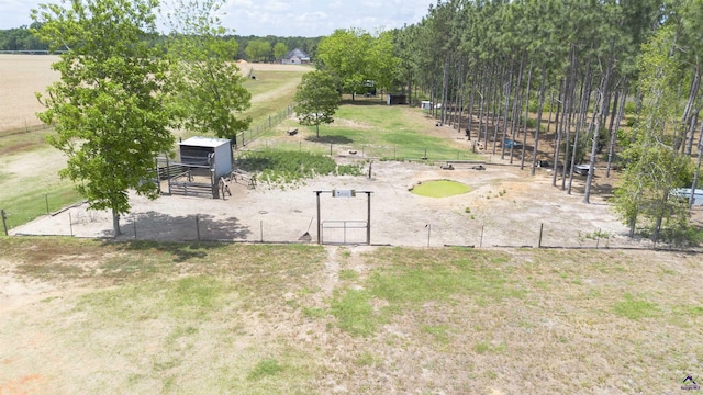 view of home's community featuring fence, an outdoor structure, and an exterior structure