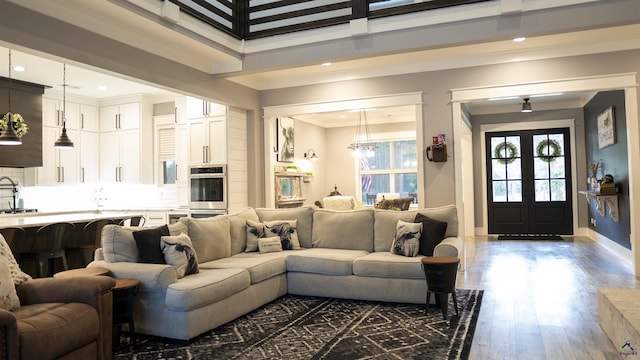 living room with baseboards, a towering ceiling, dark wood-style floors, and recessed lighting