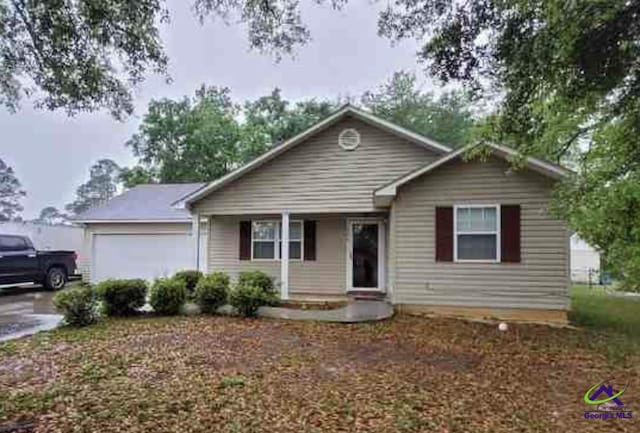 ranch-style home with covered porch and a garage