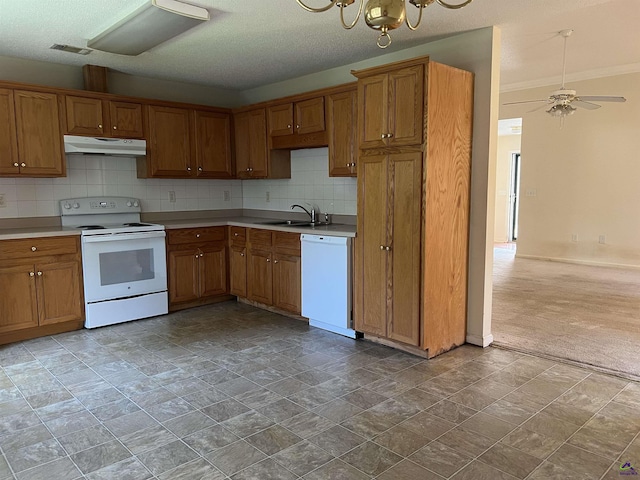 113 Easy St, Dublin, GA 31021 - kitchen featuring white appliances, under cabinet range hood, and brown cabinets