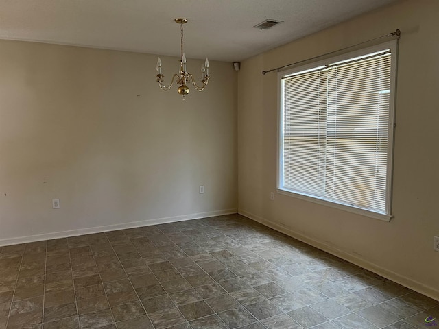 113 Easy St, Dublin, GA 31021 - empty room featuring a chandelier, baseboards, and stone finish flooring