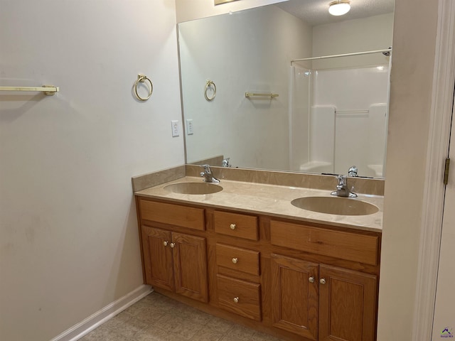 113 Easy St, Dublin, GA 31021 - bathroom featuring double vanity, a shower, and baseboards