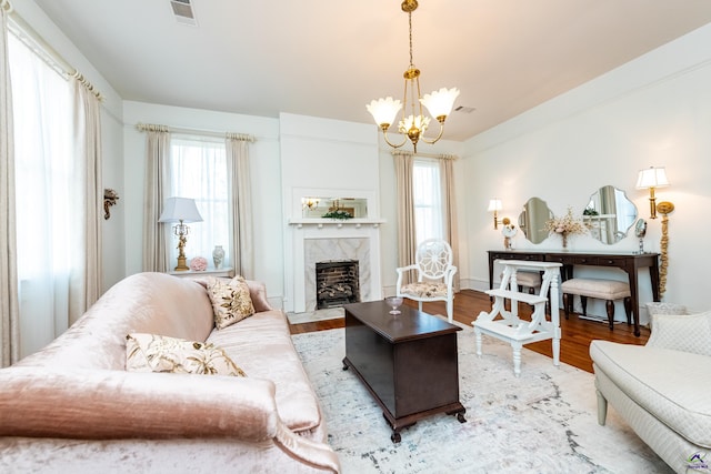 living room featuring visible vents, plenty of natural light, and wood finished floors