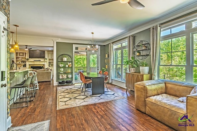 1122 Irongate, Macon, GA 31220 - dining room featuring a fireplace, crown molding, dark wood-style flooring, and a ceiling fan