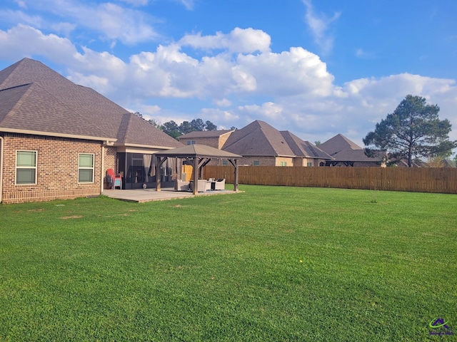 view of yard with an outdoor hangout area, a gazebo, a patio area, and a fenced backyard