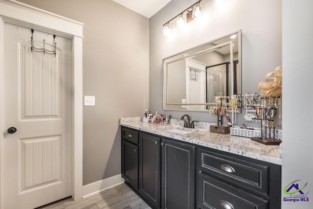 217 Woodlands Blvd, Kathleen, GA 31047 - bathroom featuring wood finished floors, vanity, and baseboards