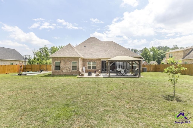 217 Woodlands Blvd, Kathleen, GA 31047 - rear view of property featuring a gazebo, a patio area, brick siding, central AC, and roof with shingles