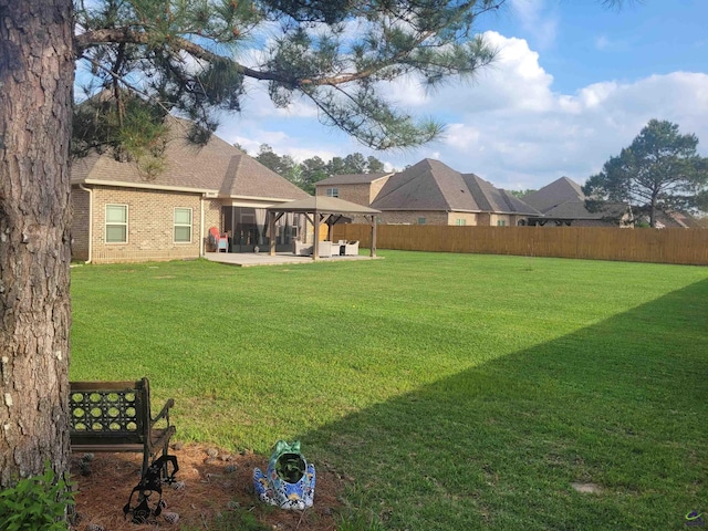 view of yard featuring a fenced backyard, a gazebo, and a patio area