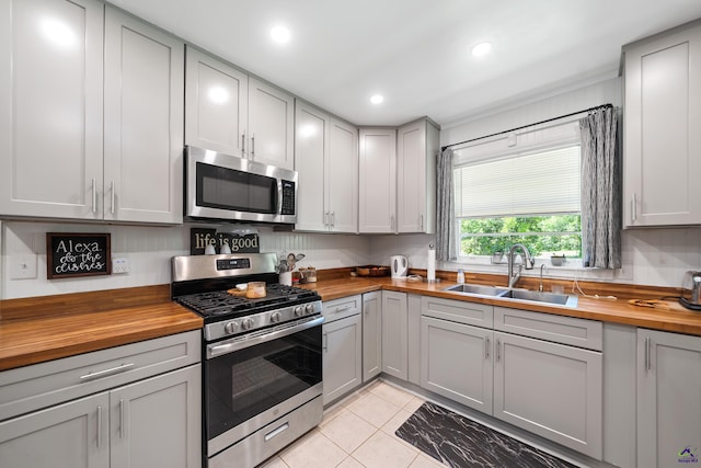 718 Dogwood Cir, Macon, GA 31210 - kitchen with wood counters, gray cabinetry, a sink, and appliances with stainless steel finishes