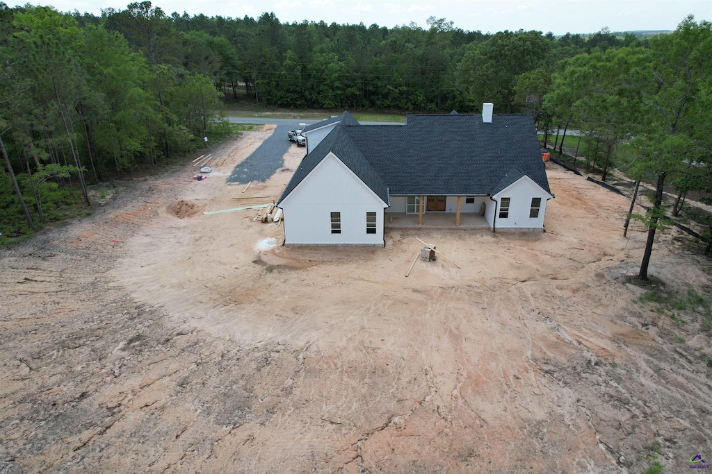 drone / aerial view featuring a view of trees