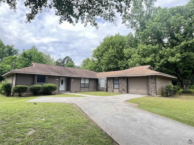 ranch-style home with stone siding, driveway, a garage, and a front lawn