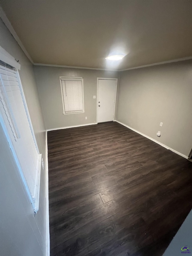 318 Vick St, Albany, GA 31705 - spare room with dark wood-style flooring, ornamental molding, and baseboards