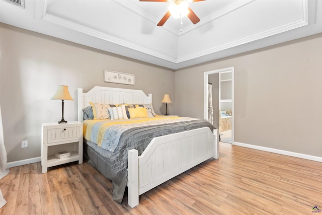 bedroom with baseboards, a raised ceiling, ceiling fan, and wood finished floors