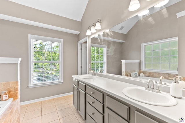bathroom featuring a bath, lofted ceiling, and a sink
