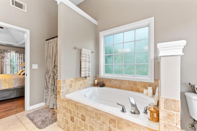 bathroom with ensuite bath, visible vents, a bath, tile patterned flooring, and crown molding