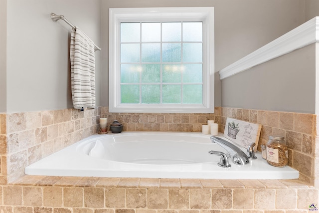 full bathroom with a bath and plenty of natural light