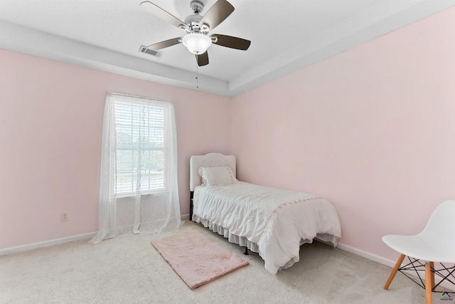 carpeted bedroom featuring visible vents, baseboards, and a ceiling fan