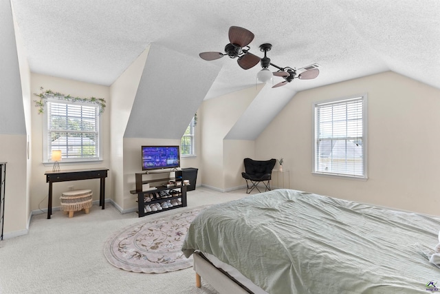 bedroom with vaulted ceiling, carpet floors, and baseboards