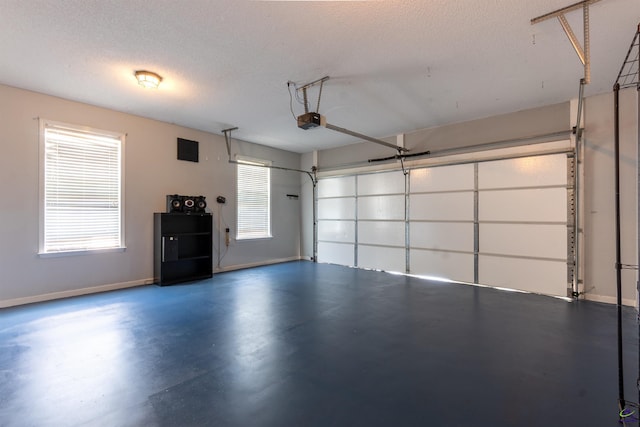 garage with baseboards and a garage door opener