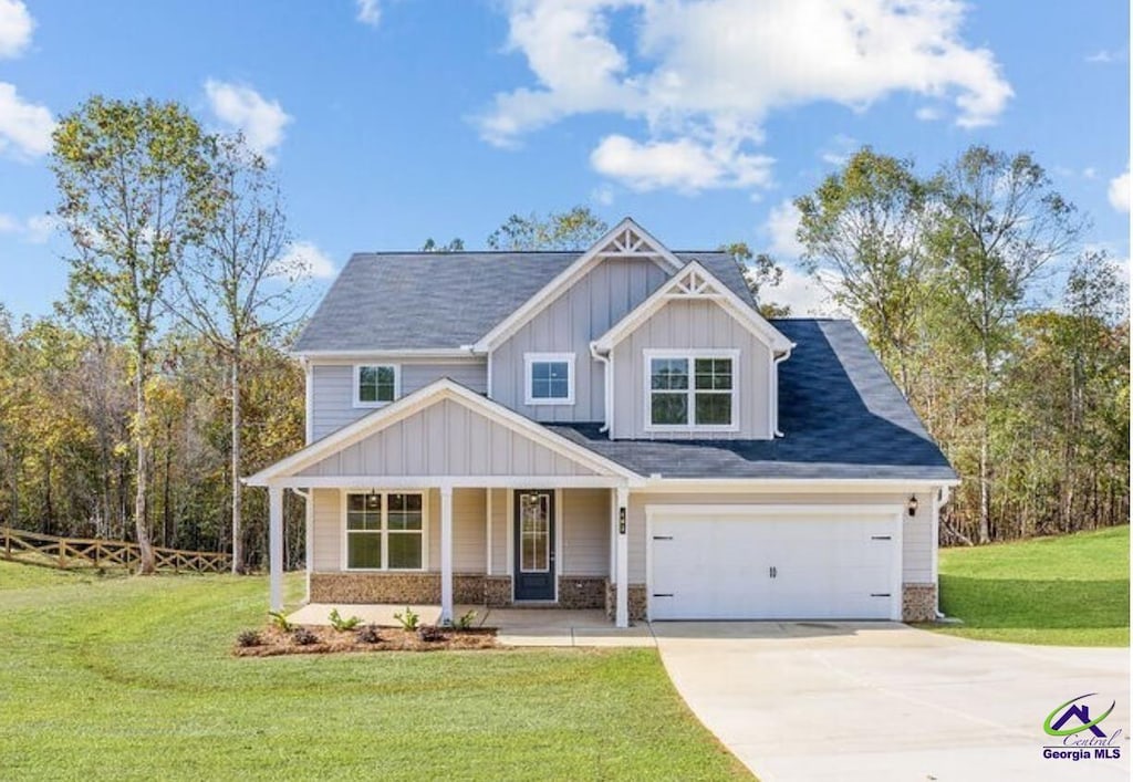 192 Chapman Ridge Rd, Macon, GA 31211 - craftsman-style house with driveway, covered porch, board and batten siding, and a front yard