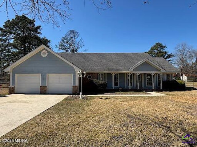 4211 Cyndy Jo Cir, Macon, GA 31216 - view of front facade with an attached garage, a front lawn, concrete driveway, and a porch