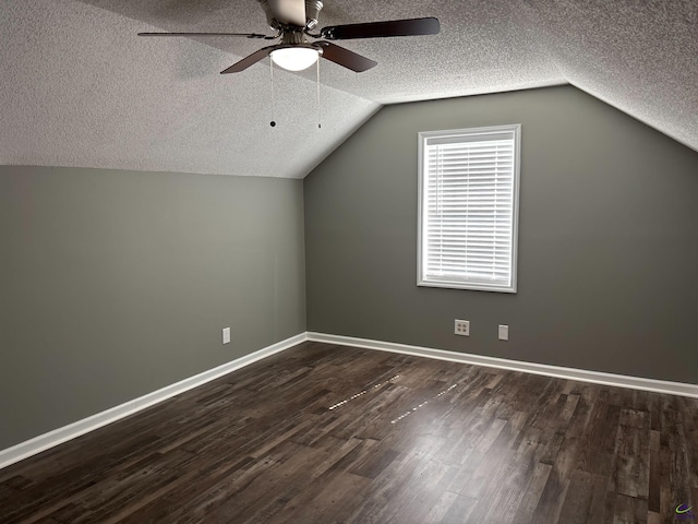4211 Cyndy Jo Cir, Macon, GA 31216 - additional living space featuring a textured ceiling, ceiling fan, dark wood-type flooring, lofted ceiling, and baseboards