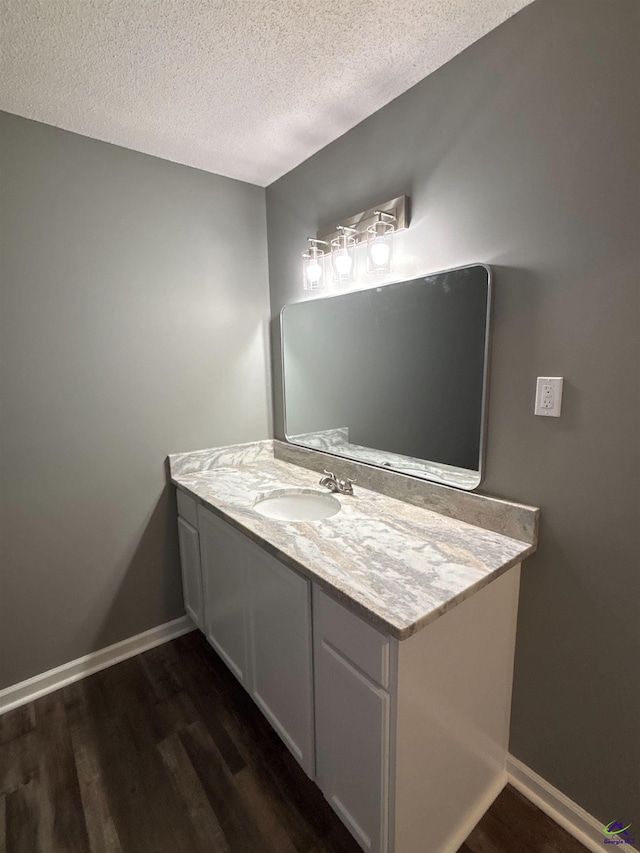 4211 Cyndy Jo Cir, Macon, GA 31216 - bathroom featuring wood finished floors, a textured ceiling, vanity, and baseboards
