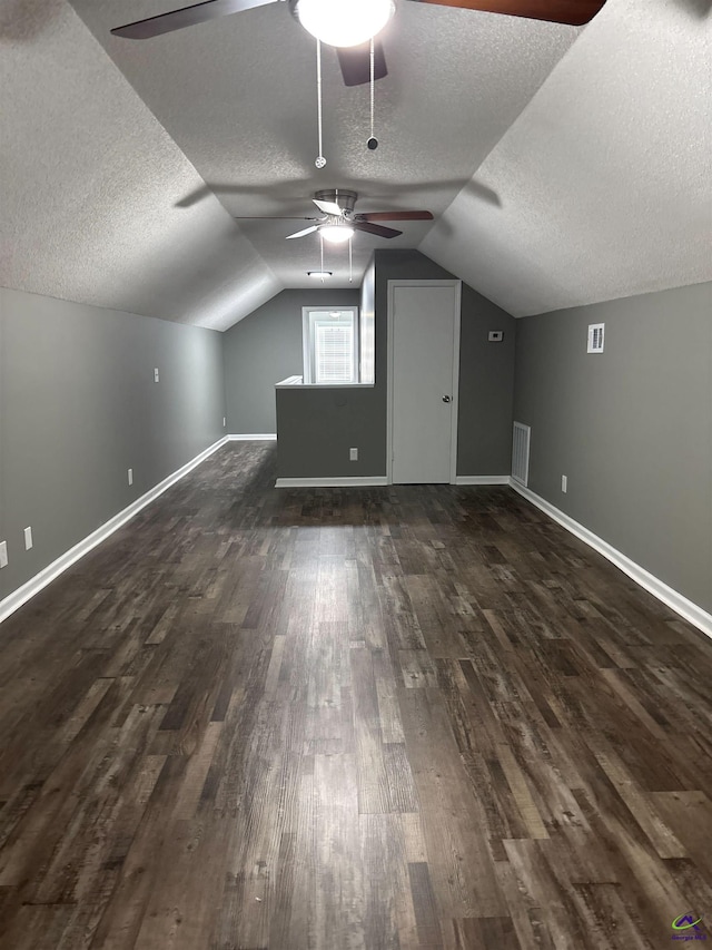 4211 Cyndy Jo Cir, Macon, GA 31216 - bonus room featuring a textured ceiling, a ceiling fan, dark wood finished floors, baseboards, and vaulted ceiling