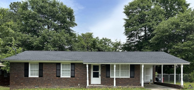 1575 Winston Dr, Macon, GA 31206 - single story home with brick siding, a shingled roof, crawl space, a carport, and a porch