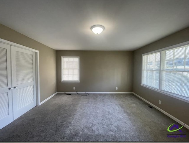 1575 Winston Dr, Macon, GA 31206 - unfurnished bedroom with carpet floors, baseboards, and a closet