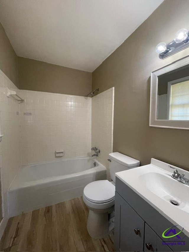 1575 Winston Dr, Macon, GA 31206 - bathroom with wood finished floors,  shower combination, toilet, and vanity