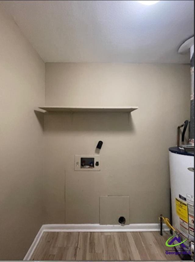 1575 Winston Dr, Macon, GA 31206 - washroom with water heater, hookup for a washing machine, hookup for an electric dryer, wood finished floors, and baseboards