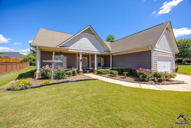 view of front of property with an attached garage, covered porch, driveway, and board and batten siding