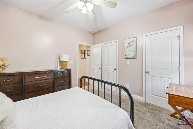 carpeted bedroom with baseboards and a ceiling fan
