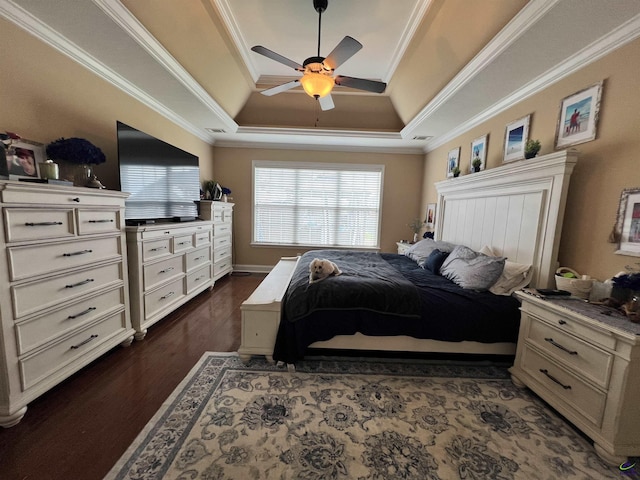 bedroom with a raised ceiling, ornamental molding, dark wood-style flooring, and a ceiling fan