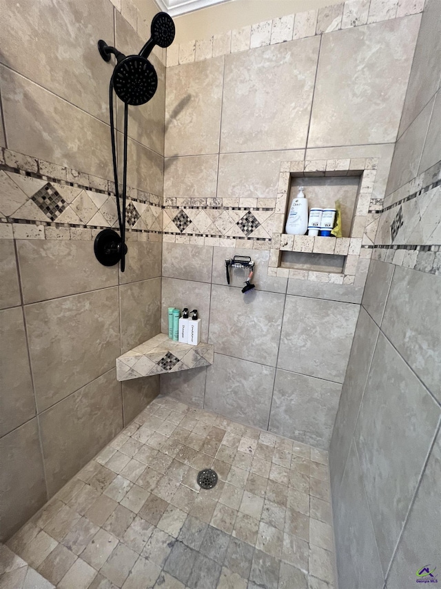 bathroom with a tile shower