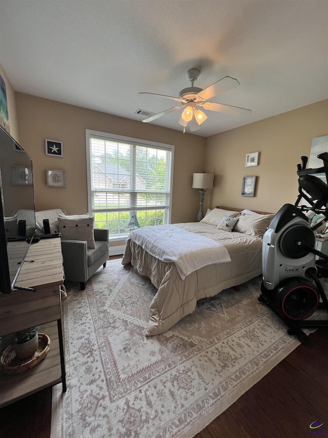 bedroom featuring wood finished floors and a ceiling fan
