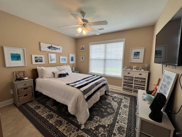 bedroom featuring baseboards, a ceiling fan, and tile patterned floors