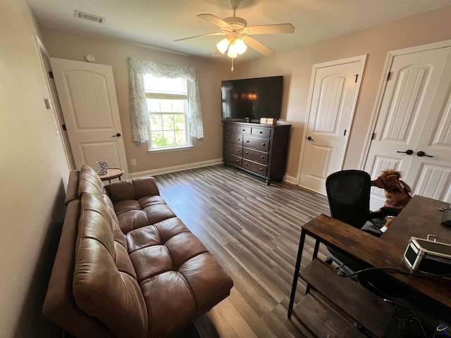 living room featuring ceiling fan, wood finished floors, and baseboards
