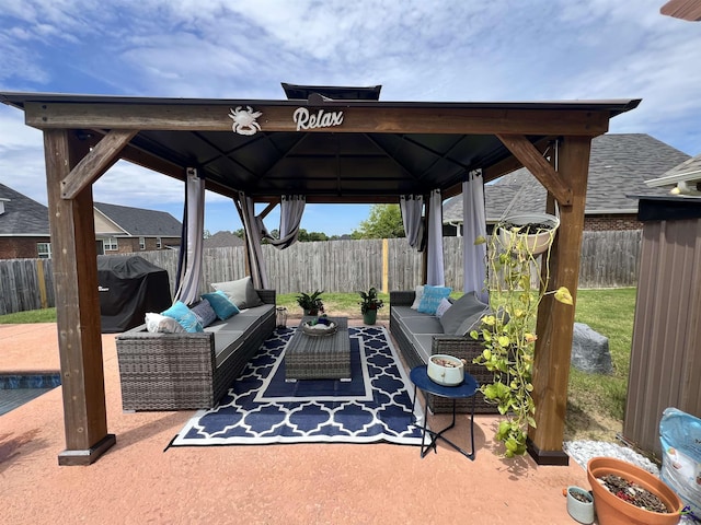 view of patio with a gazebo, an outdoor hangout area, and a fenced backyard