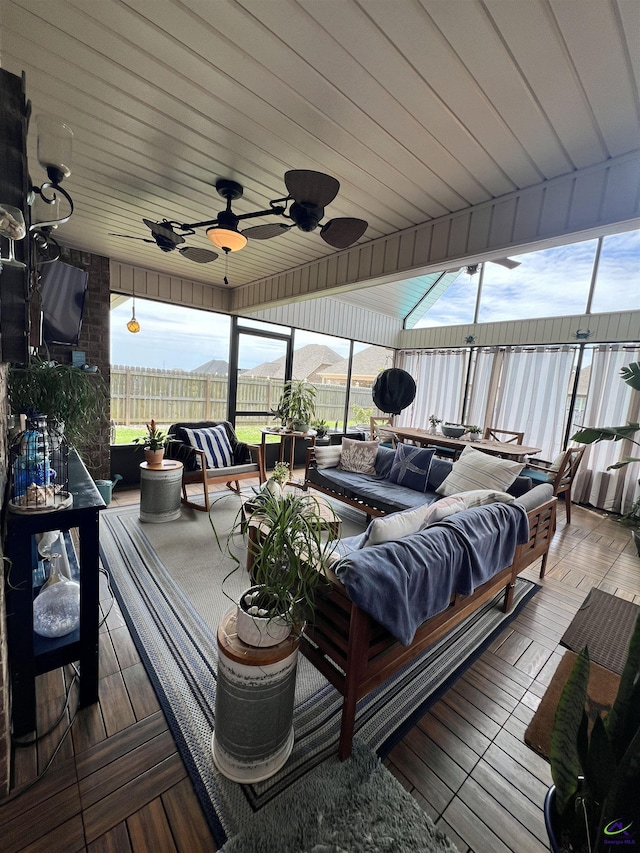wooden terrace featuring an outdoor hangout area, fence, and ceiling fan