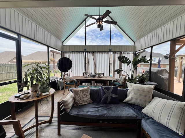 sunroom / solarium with outdoor dining area, ceiling fan, and vaulted ceiling